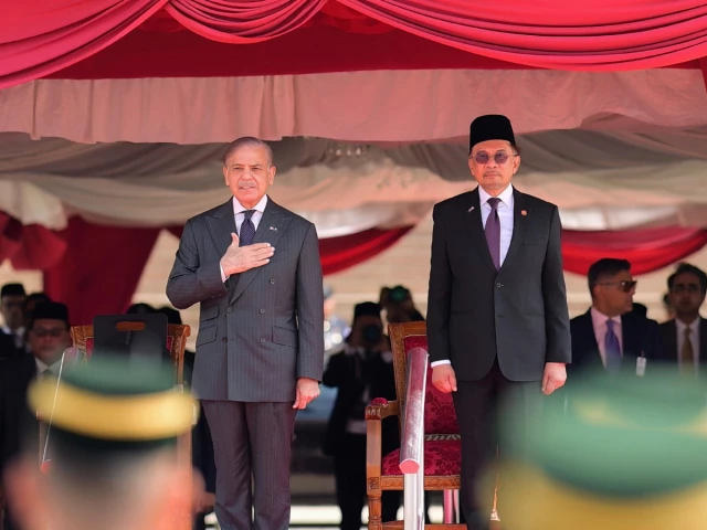 prime minister muhammad shehbaz sharif inspects the guard of honour at malaysian prime minister s office source x