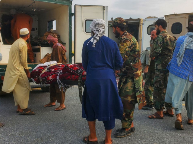 Taliban soldiers and civilians carry earthquake victims to an ambulance at an airport in Jalalabad, Afghanistan, September 1, 2025. REUTERS