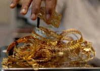a goldsmith weighs gold jewellery inside a showroom in ahmedabad reuters a goldsmith weighs gold jewellery inside a showroom in ahmedabad reuters