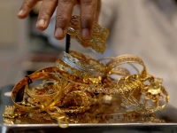 a goldsmith weighs gold jewellery inside a showroom in ahmedabad reuters a goldsmith weighs gold jewellery inside a showroom in ahmedabad reuters