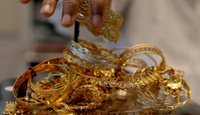 a goldsmith weighs gold jewellery inside a showroom in ahmedabad reuters
