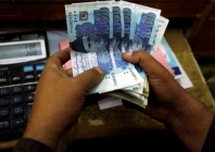 a trader counts pakistani rupee notes at a currency exchange booth in peshawar pakistan december 3 2018 reuters