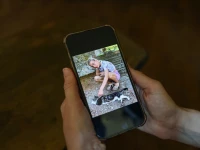 irene roggero ugues whose 12 year old daughter took her own life in 2024 holds a mobile phone displaying a photograph of her daughter during an interview with reuters at a cafe in asti italy photo reuters