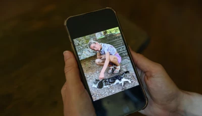 irene roggero ugues whose 12 year old daughter took her own life in 2024 holds a mobile phone displaying a photograph of her daughter during an interview with reuters at a cafe in asti italy photo reuters