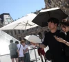 two people shelter under an umbrella and use a fan outside the louvre amid a severe heat wave in paris france photo reuters