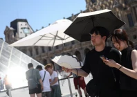 two people shelter under an umbrella and use a fan outside the louvre amid a severe heat wave in paris france photo reuters