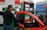 a driver fills up his tank at a gas station photo reuters