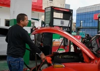 a driver fills up his tank at a gas station photo reuters