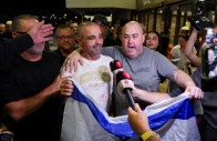 yaniv hayun one of the men who helped incapacitate the attacker on the flydubai aircraft bound for israel from the united arab emirates which was diverted to saudi arabia following an emergency signal holds an israeli flag as he appears in front of the members of the media after arriving at the ben gurion international airport in lod near tel aviv israel photo reuters