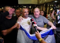 yaniv hayun one of the men who helped incapacitate the attacker on the flydubai aircraft bound for israel from the united arab emirates which was diverted to saudi arabia following an emergency signal holds an israeli flag as he appears in front of the members of the media after arriving at the ben gurion international airport in lod near tel aviv israel photo reuters
