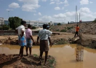farmers speak with a security guard near the compound wall of a tata electronics components factory for apple s iphone in hosur photo reuters
