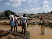 farmers speak with a security guard near the compound wall of a tata electronics components factory for apple s iphone in hosur photo reuters