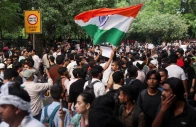 a supporter of india s cockroach janata party cjp holds an indian national flag at the ongoing protest site a few days after thousands of protesters marched towards parliament demanding the resignation of education minister dharmendra pradhan over national eligibility cum entrance test neet examination paper leaks at jantar mantar in new delhi india photo reuters