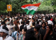 a supporter of india s cockroach janata party cjp holds an indian national flag at the ongoing protest site a few days after thousands of protesters marched towards parliament demanding the resignation of education minister dharmendra pradhan over national eligibility cum entrance test neet examination paper leaks at jantar mantar in new delhi india photo reuters