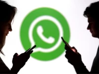 teenagers pose for a photo while holding smartphones in front of a whatsapp logo in this illustration photo reuters