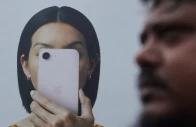 a man walks past an apple iphone hoarding on a street in mumbai india photo reuters