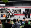 people watch as a technician works at the site after a deadly collision between a commuter line train and a long distance train in bekasi on the outskirts of jakarta photo reuters