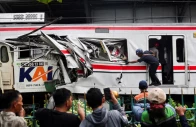 people watch as a technician works at the site after a deadly collision between a commuter line train and a long distance train in bekasi on the outskirts of jakarta photo reuters