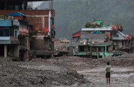 a man takes pictures in front of damaged buildings after flash floods and a mudslide in trishuli nuwakot district nepal photo reuters a man takes pictures in front of damaged buildings after flash floods and a mudslide in trishuli nuwakot district nepal photo reuters