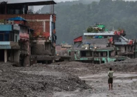 a man takes pictures in front of damaged buildings after flash floods and a mudslide in trishuli nuwakot district nepal photo reuters a man takes pictures in front of damaged buildings after flash floods and a mudslide in trishuli nuwakot district nepal photo reuters