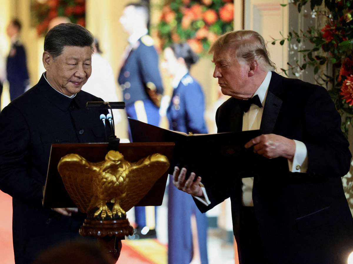 US President Donald Trump holds a binder as he stands next to Chinese President Xi Jinping before Xi delivers a speech during a state dinner at the White House in Washington, DC, US. Photo: Reuters