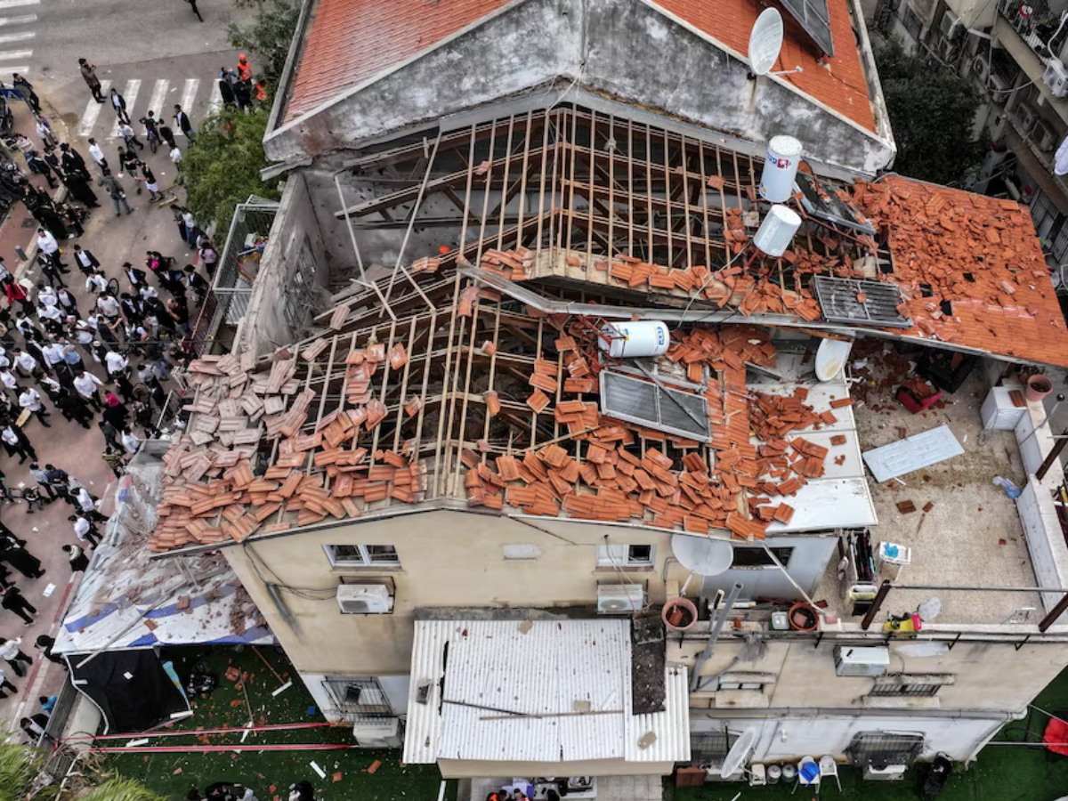 A drone view of people gathering at the site of damage in a residential neighbourhood following Iranian missile barrages in central Israel. PHOTO: REUTERS