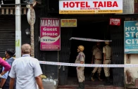 firefighters stand at an entryway to a hotel where a fire broke out and killed several people in kolkata india photo reuters