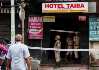 firefighters stand at an entryway to a hotel where a fire broke out and killed several people in kolkata india photo reuters