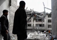 a man looks at a residential building damaged by a strike amid the us israeli conflict with iran in tehran iran photo reuters