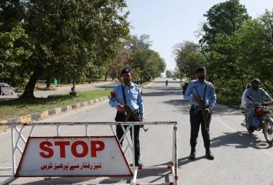 police officers stand at a check post on a road leading to the serena hotel as pakistan prepares to host the us and iran for peace talks in islamabad photo reuters