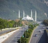 people commute on a road near faisal mosque as pakistan prepares to host the us and iran for peace talks in islamabad photo reuters