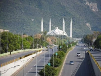 people commute on a road near faisal mosque as pakistan prepares to host the us and iran for peace talks in islamabad photo reuters