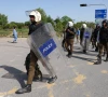 police officers equipped with riot gear walk at d chowk area near the president s house as pakistan prepares to host the us and iran for peace talks in islamabad photo reuters