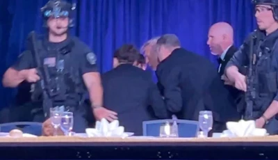 us president donald trump is escorted out as a shooter opens fire during the annual white house correspondents association dinner in washington dc photo reuters