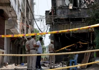 police officers stand at the site a day after a fire at a hotel in new delhi india photo reuters