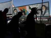 people walk past a mural depicting the late leader of the islamic revolution ayatollah ruhollah khomeini and iran s late supreme leader ayatollah ali khamenei in tehran iran photo reuters
