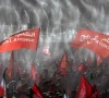 mourners wave flags under water sprinklers during a public farewell ceremony to pay their respects to late supreme leader ayatollah ali khamenei at the imam khomeini grand mosalla in tehran iran photo reuters