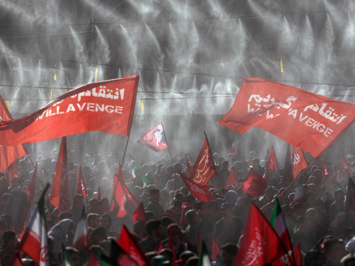Mourners wave flags under water sprinklers during a public farewell ceremony to pay their respects to late Supreme Leader Ayatollah Ali Khamenei at the Imam Khomeini Grand Mosalla, in Tehran, Iran. Photo: Reuters
