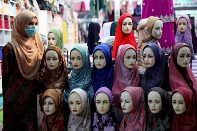 a shopkeeper wearing a mask waits for customers at a hijab shop following the outbreak of the coronavirus in kuala lumpur malaysia march 6 2020 reuters lim huey teng file photo acquire licensing rights a shopkeeper wearing a mask waits for customers at a hijab shop following the outbreak of the coronavirus in kuala lumpur malaysia march 6 2020 reuters lim huey teng file photo acquire licensing rights