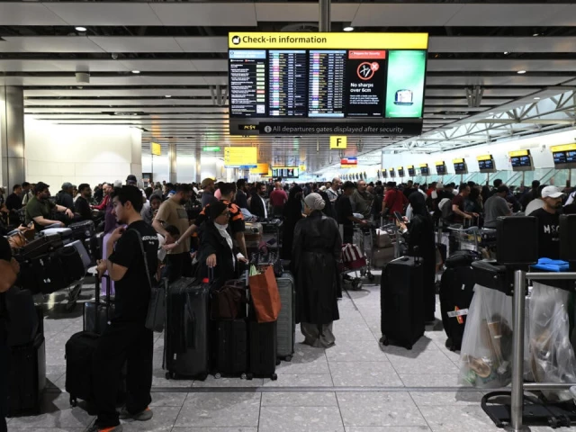 travellers wait at london s heathrow airport one of the major european airports including brussels and berlin hit by a cyberattack photo afp