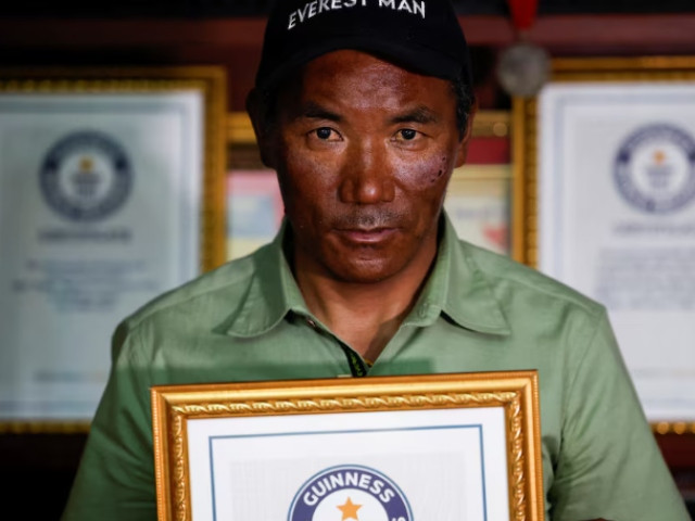 kami rita sherpa 53 a nepali mountaineer who climbed mount everest for a record 28 times surrounded by his previous guinness world record certificates poses for a picture at his rented apartment in kathmandu nepal may 28 2023 photo reuters