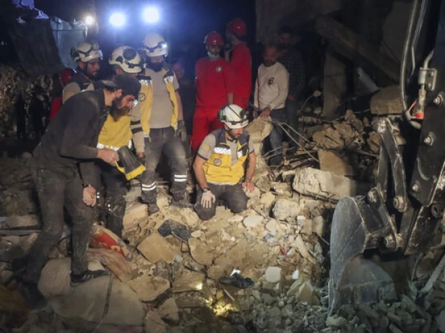 in this photo provided by the syrian civil defense white helmets members of their team search through the debris of a four story building after an ordnance from syria s 13 conflict exploded in the coastal city of latakia syria early sunday march 16 2025 2025 photo ap