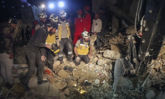 in this photo provided by the syrian civil defense white helmets members of their team search through the debris of a four story building after an ordnance from syria s 13 conflict exploded in the coastal city of latakia syria early sunday march 16 2025 2025 photo ap