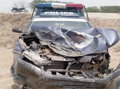 karachi police mobile rolls into ditch after collision with dumper