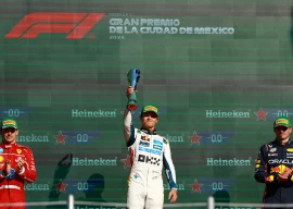 mclaren s lando norris celebrates with a trophy on the podium after winning the mexico city grand prix alongside second placed ferrari s charles leclerc and third placed red bull s max verstappen photo reuters