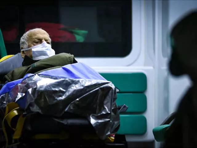 an old man wearing a face mask being evacuated from a geriatric clinic photo afp an old man wearing a face mask being evacuated from a geriatric clinic photo afp