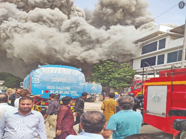 a massive fire engulfs a garment factory in landhi industrial area sending thick plumes of black smoke into the sky and reducing finished goods to ashes photo express