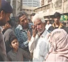 a family member of a gul plaza salesman wipes away tears while standing before the charred remains of the building mourning the loss of a lifetime of work and memories in the devastating fire photo app