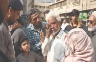 a family member of a gul plaza salesman wipes away tears while standing before the charred remains of the building mourning the loss of a lifetime of work and memories in the devastating fire photo app