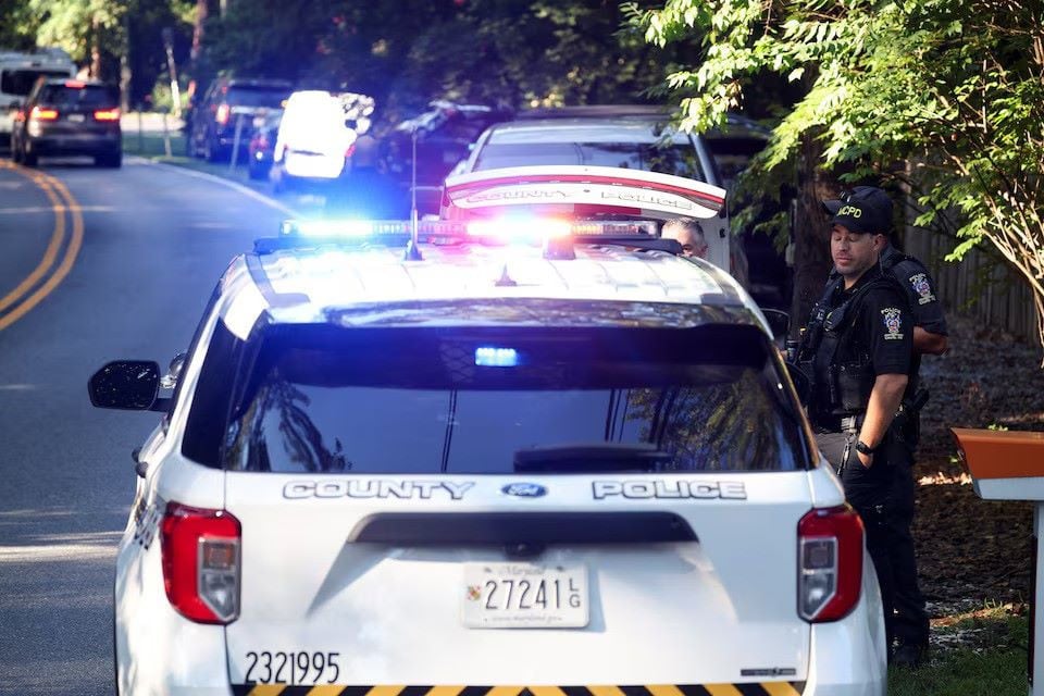 Police officers stand outside the home of the former White House national security adviser John Bolton as it is searched by FBI members, in Bethesda, Maryland, U.S., August 22, 2025. REUTERS